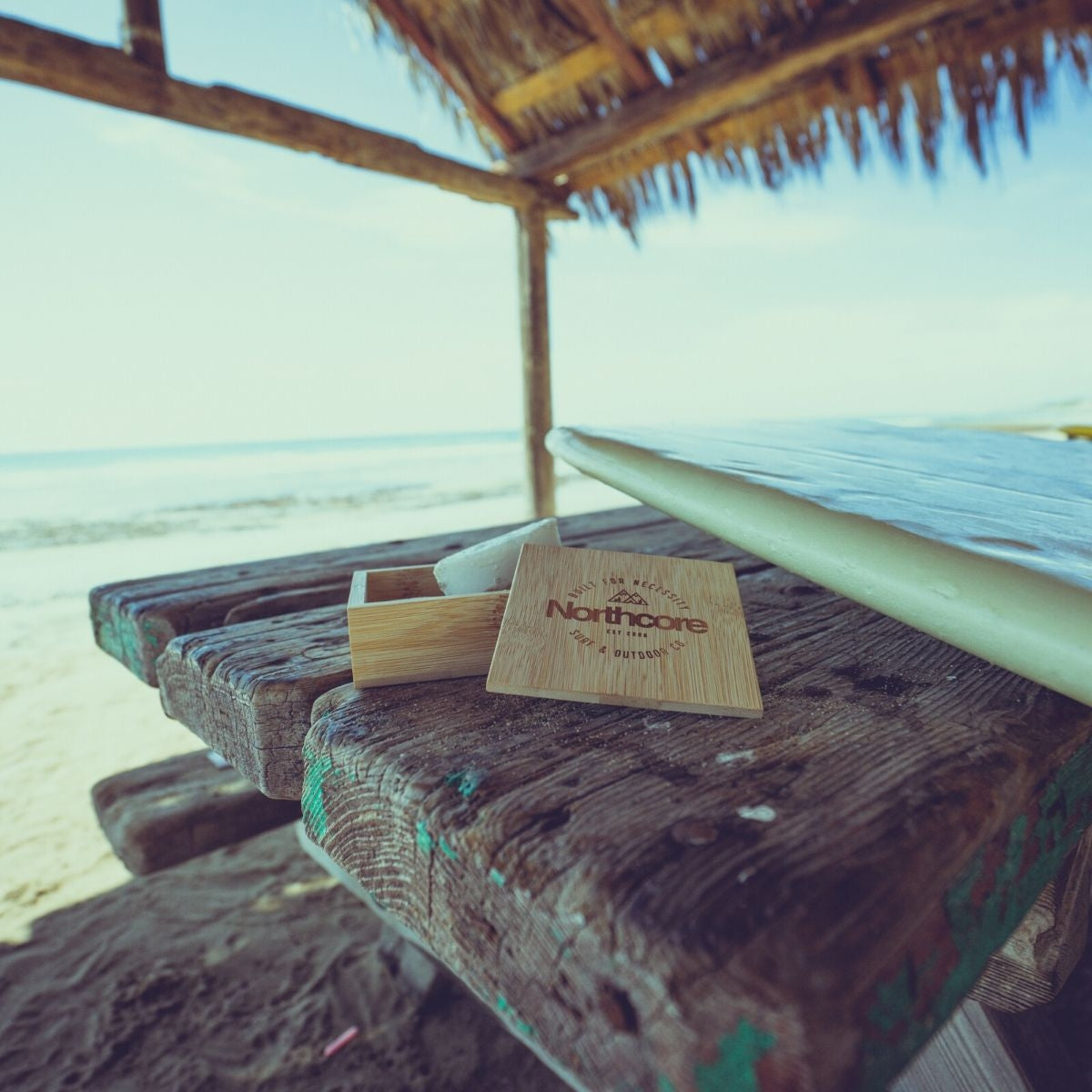 surf wax box made from bamboo on a beach in California